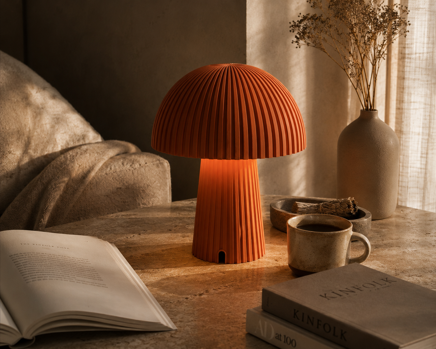 Maxi Mush terracotta table lamp glowing in a warm, collected living space.