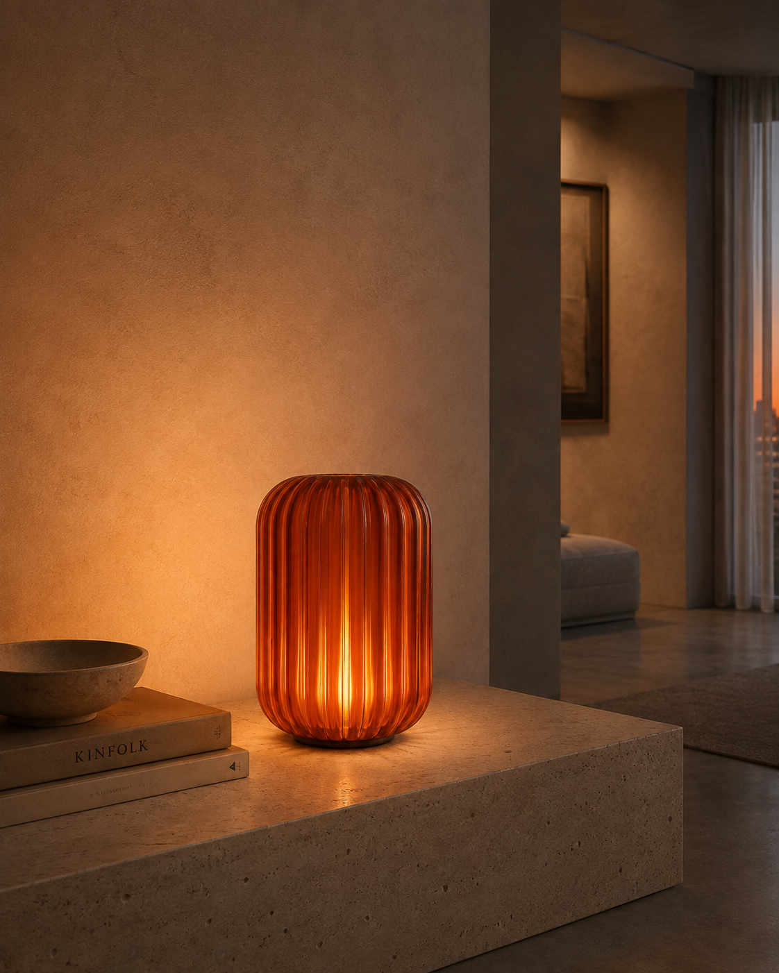 Aura Amber table lamp glowing on a travertine ledge in a warm interior.