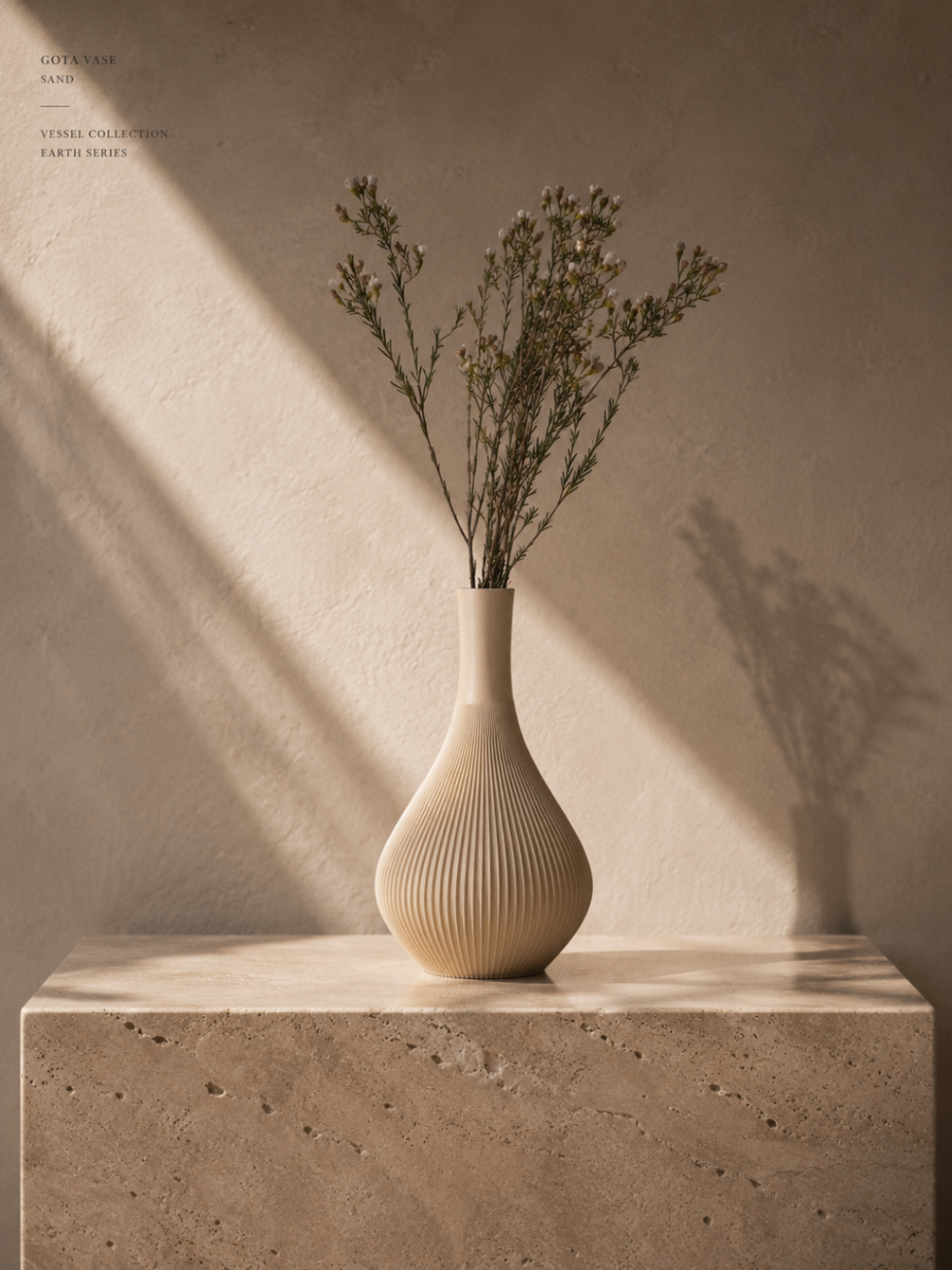 Gota Sand vase resting on a warm neutral surface.